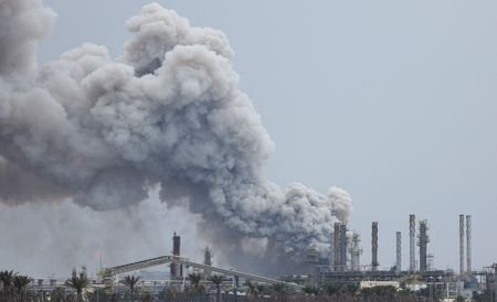 Smoke rises following a strike in Sitra Island