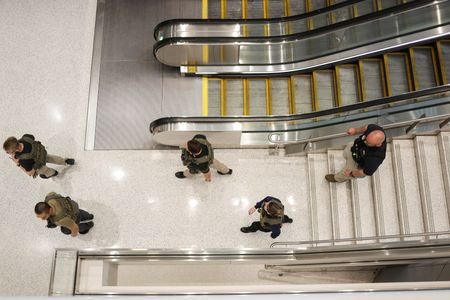 Immigration and Customs Enforcement agents walk at Newark Liberty International
