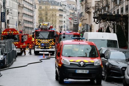 French firefighters work a fire broke out at Paris luxury
