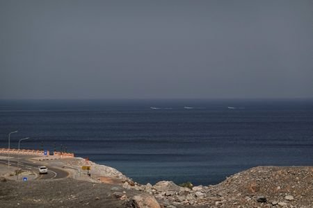 A car rides along the coast of Musandam overlooking the