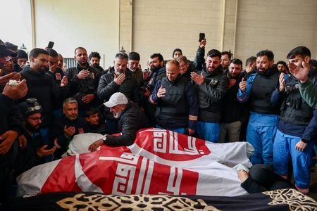 People mourn two paramedics killed by Israeli strike, in Nabatieh