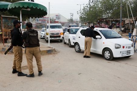 Police officers check vehicles as a security measure, following exchanges