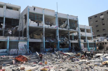Palestinians inspect the site of evacuated UNRWA school following Israeli