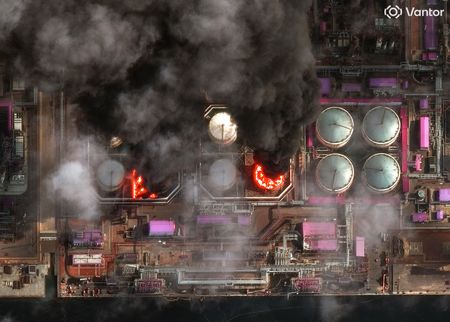 A satellite near-infrared image shows smoke rising from oil storage