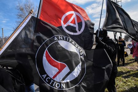 Members of the Great Lakes anti-fascist organization (Antifa) fly flags