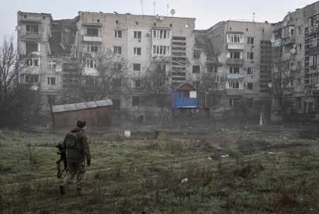 FILE PHOTO: A Ukrainian service member walks in the frontline