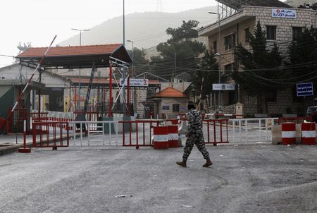 A man walks near the closed Lebanese-Syrian border checkpoint amid