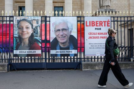 Posters of Cecile Kohler and Jacques Paris in front of