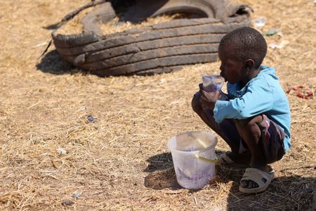 FILE PHOTO: A boy waits for customers to sell bags