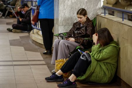 People take shelter inside a metro station during an air