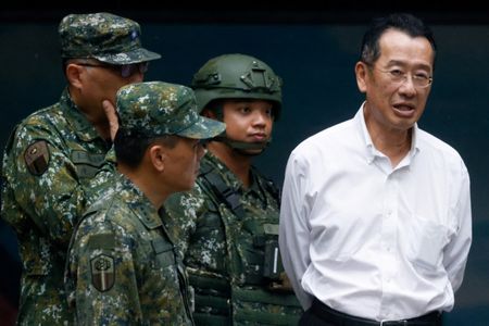 Taiwan's Defence Minister Wellington Koo reacts after visiting a reservists