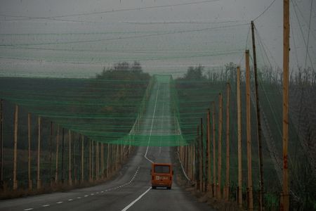 FILE PHOTO: A car drives along a road covered with