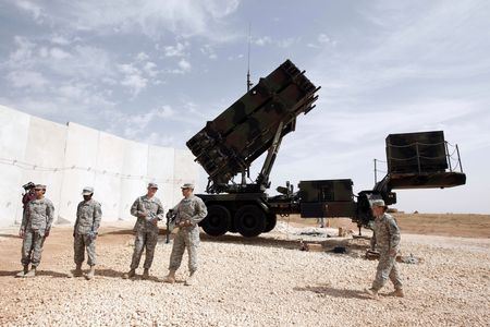 U.S. soldiers stand beside a U.S. Patriot missile system at