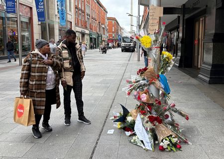Flowers are laid outside a department store at Henry Street,