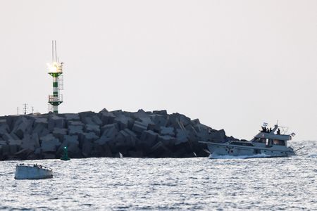 Israeli soldiers are seen on a vessel bearing symbols of