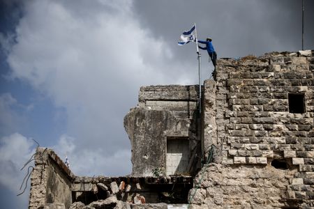 Israeli settlers celebrate the re-establishment of the settlement of Sa-Nur