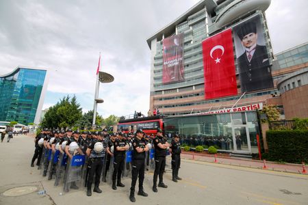 Riot police stand guard outside the CHP headquarters in Ankara