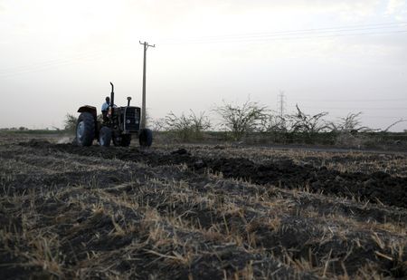 A tractor is used to plow the land at an