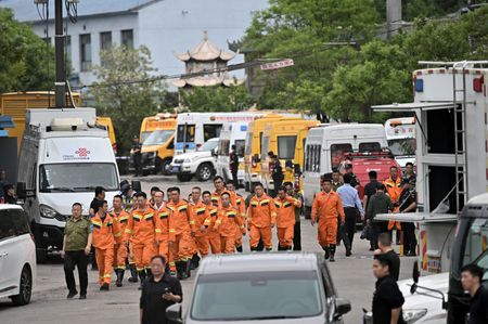 Rescuers work at the site following a gas explosion at