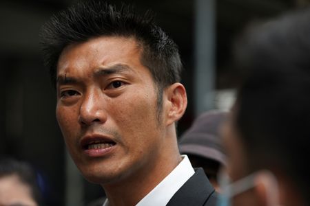 Banned opposition politician Thanathorn Juangroongruangkit turns up at a police