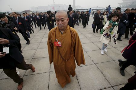 Buddhist abbot Shi Yongxin, a delegate of the NPC, walks