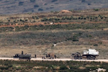 Israeli soldiers near vehicles in Lebanon
