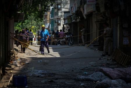 People walk past the site a day after a fire