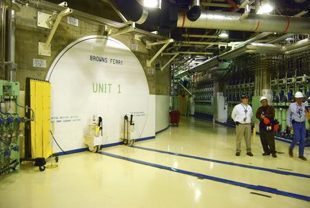 Nuclear officials stand near the entrance to a reactor at