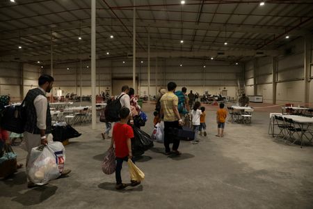 Special Immigrants from Afghanistan walk through the in-processing building after