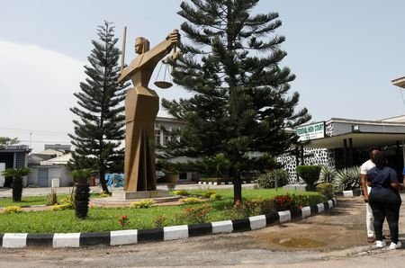 People stand outside the Federal High Court in Lagos