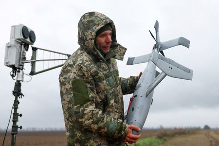 FILE PHOTO: Ukrainian serviceman carries an interceptor drone, part of
