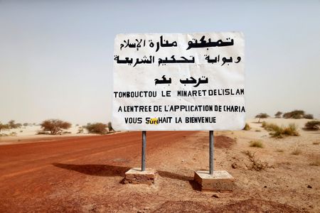FILE PHOTO: A road sign written by Islamist rebels is