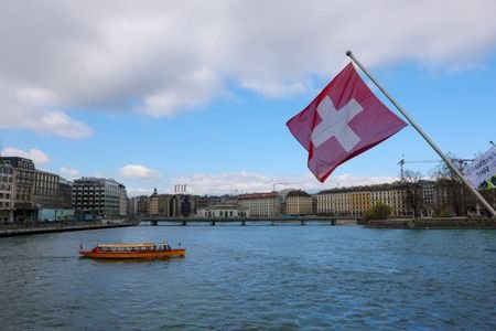 A Swiss flag and a mouette boat in Geneva