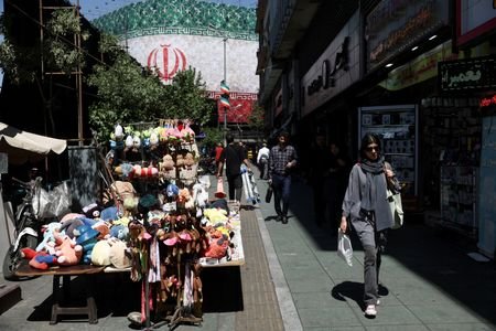 An Iranian woman walks on a street, in Tehran