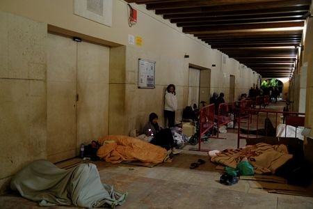 Migrants aiming to become legal spend night outside Spanish city