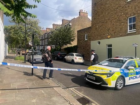 Police survey a cordoned off street, where a fire broke