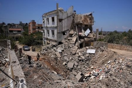 People inspect the damage in the Nabatieh district