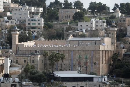 FILE PHOTO: Israeli flags flutter on the Ibrahimi mosque, also