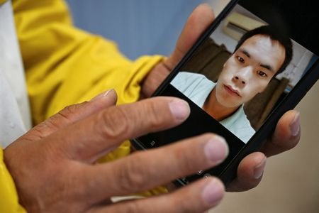 Yanfeng Ge shows a picture of his brother, Chaofeng Ge,