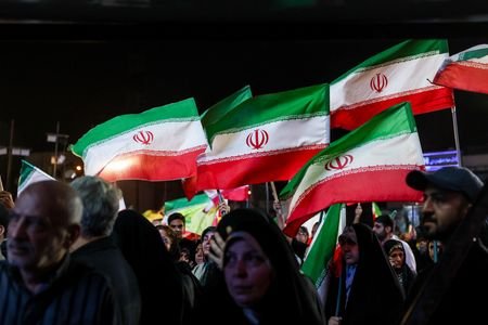 People attend a rally in Tehran
