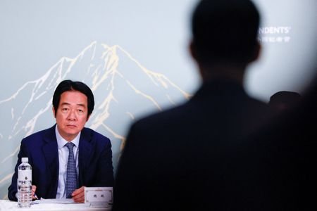 Taiwan President Lai Ching-te takes notes as a reporter asks