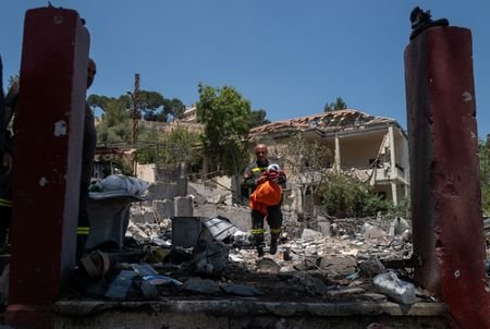 Members of the government-run Lebanese Civil Defense search for belongings