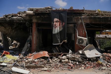 People inspect the damage in Jibchit, in the Nabatieh district,