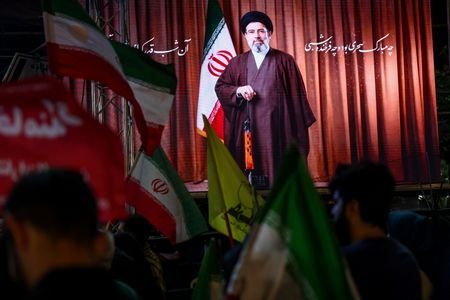 People attend a rally in Tehran