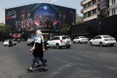 People walk on a street in Tehran