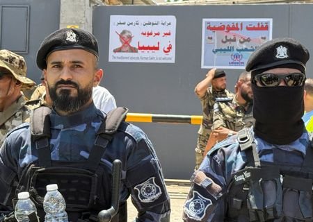 Protesters gather outside the headquarters of the UNHCR demanding the