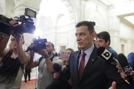 Romanian Prime Minister Grindeanu walks after a no-confidence motion in