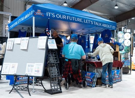 Visitors to the Ponoka Stampede visit an Alberta Independence booth