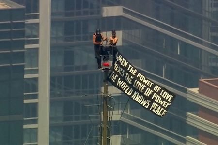 Two people display a banner atop the Empire State Building