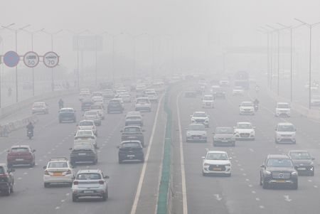 FILE PHOTO: Traffic moves along a highway amidst air pollution